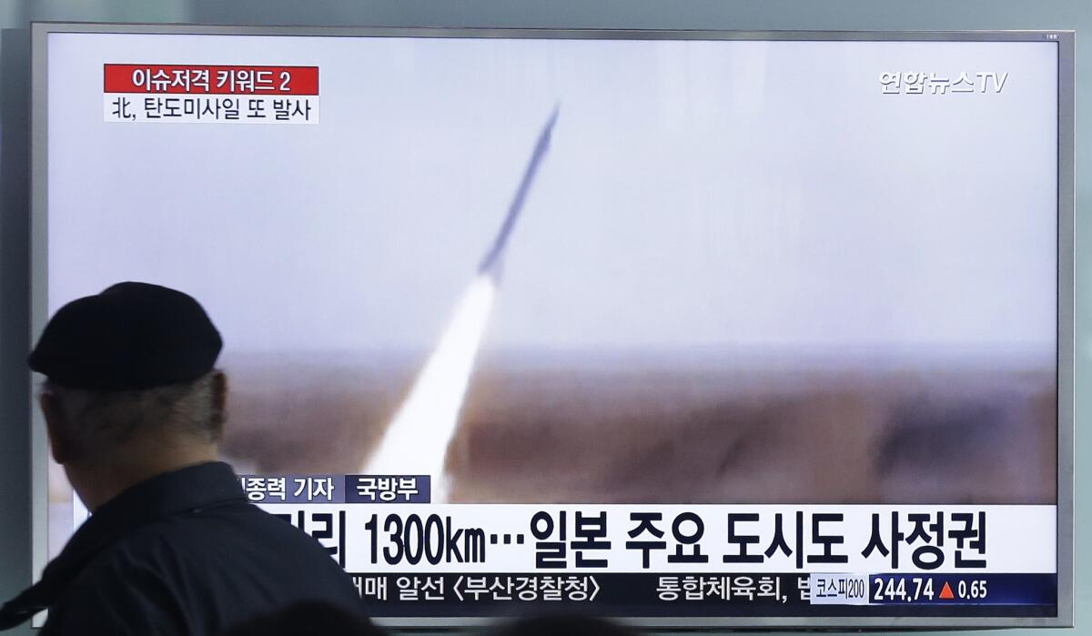A man watches a TV screen showing a file footage of the missile launch conducted by North Korea, at Seoul Railway Station in South Korea on March 18.