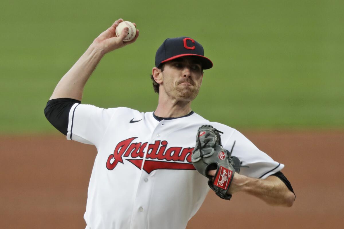 FILE - Cleveland Indians starting pitcher Shane Bieber delivers in the first inning in a baseball game against the Minnesota Twins in Cleveland, in this Tuesday, Aug. 25, 2020, file photo. For the Indians, the changes go beyond just dropping their debated name. (AP Photo/Tony Dejak, File)