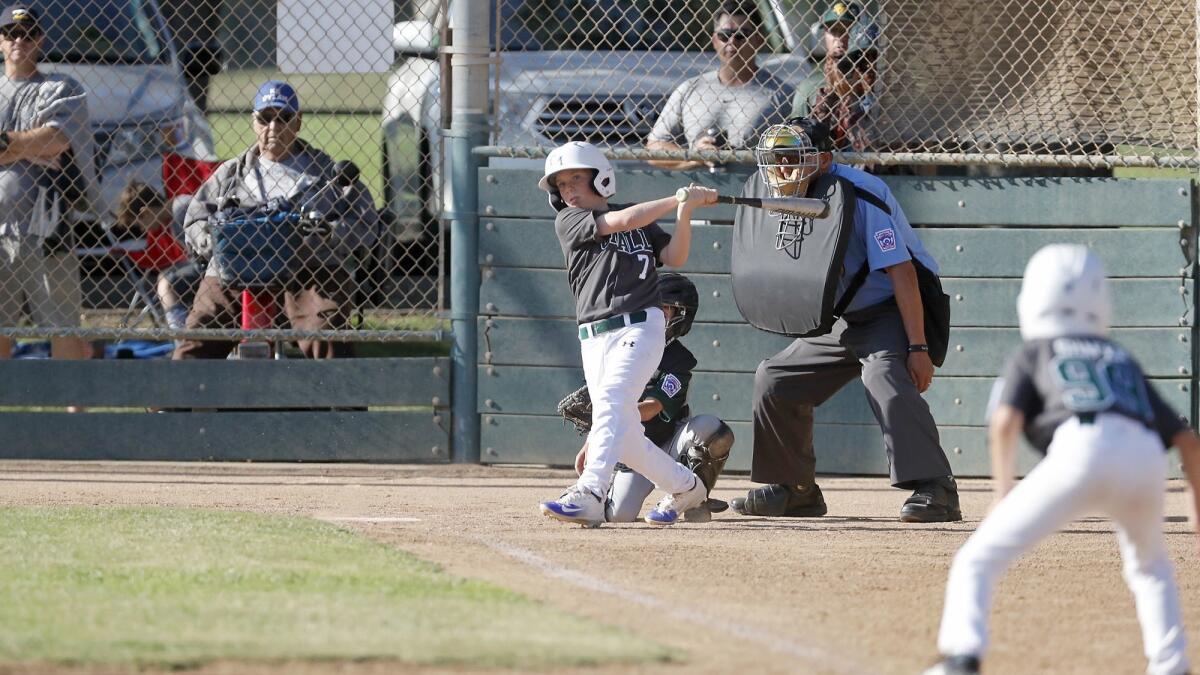 Costa Mesa American Little League's Parker Stringham bats in a run against Seaview in an 8- and 9-year-old Superstar game of the District 62 tournament on Thursday at Fountain Valley Sports Park.