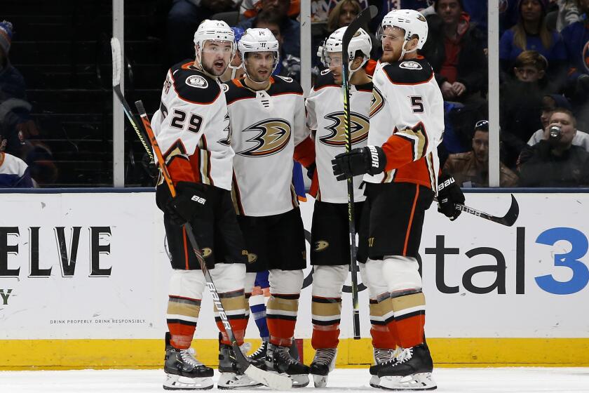 Anaheim Ducks center Adam Henrique (14) celebrates his goal against the New York Islanders with teammates Devin Shore (29), Michael Del Zotto (44) and Korbinian Holzer (5) during the second period of an NHL hockey game, Saturday, Dec. 21, 2019, in Uniondale, N.Y. (AP Photo/Jim McIsaac)