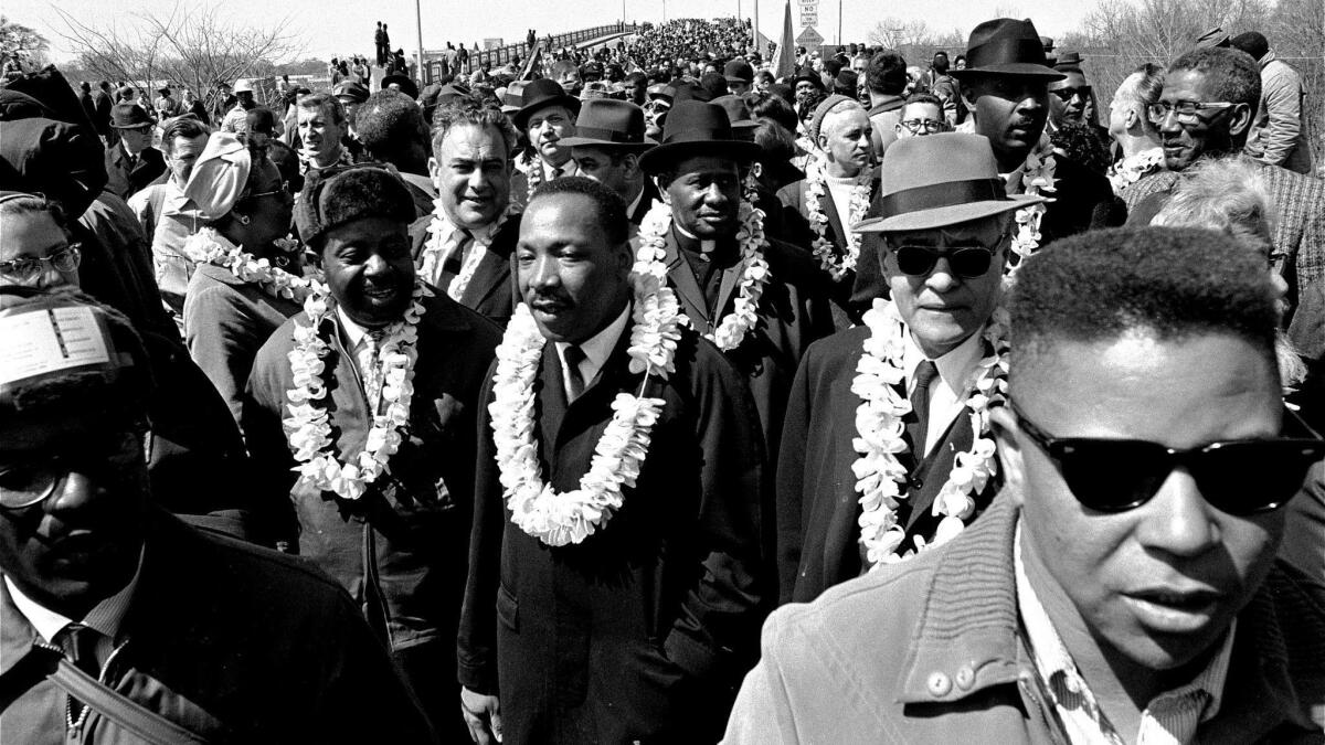 Martin Luther King, Jr. and his civil rights marchers head for Montgomery, Ala., on March 21, 1965, during a five day, 50-mile walk to protest voting laws.