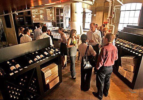 A wine-tasting group in the wine shop of Palate Food + Wine in Glendale, a restaurant, wine bar and wine shop.