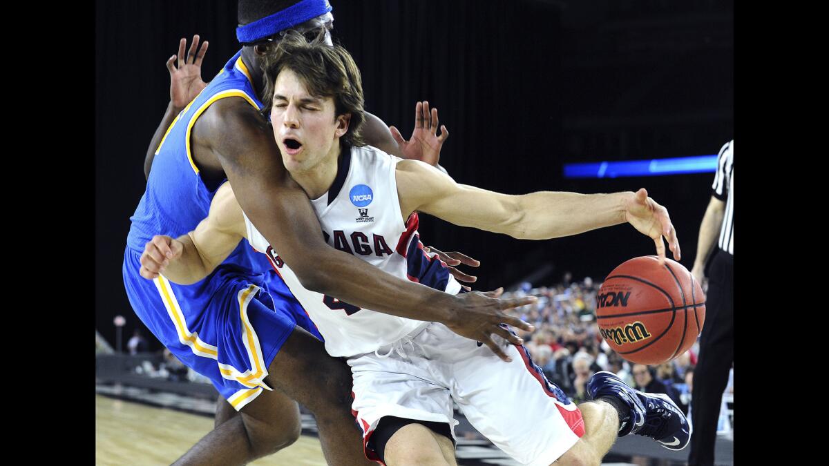 UCLA forward Kevon Looney fouls Gonzaga guard Kevin Pangos as he drives late in the South Regional semifinal game.