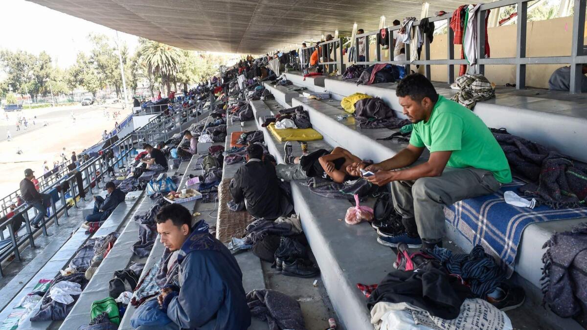 Migrants from Central America heading toward the U.S. border in a caravan rest at a sports complex in Mexico City.