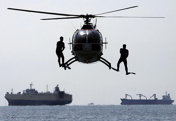 Members of the Philippine coast guard jump out of a helicopter during a disaster drill at the Assn. of South East Asian Nations, or ASEAN, Regional Forum in the capital Manila on Monday. The drill was to show preparedness in responding to a deadly super-hurricane in the Philippines.