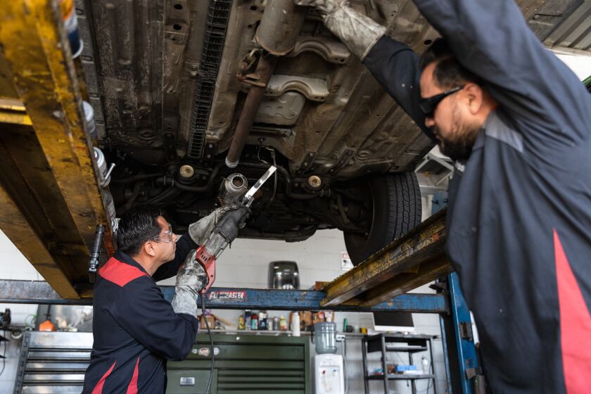 Jorge Medina, owner of Barrio Auto Service, demonstrates how a catalytic converter is quickly cut off a car at his shop in Sherman Heights on Friday, March 18, 2022. The catalytic converter was removed within seconds. State Senator Brian Jones, R-Santee, introduced SB 919, which would require dealers to permanently mark catalytic converters with a Vehicle Identification Number, require recyclers to purchase catalytic converters with an untampered VIN and increase fines for catalytic converter theft.