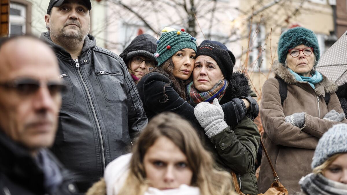 People gather in Kleber Square in central Strasbourg, France, on Sunday to pay homage to the victims of a gunman who killed five people and wounded a dozen others on Dec. 11.