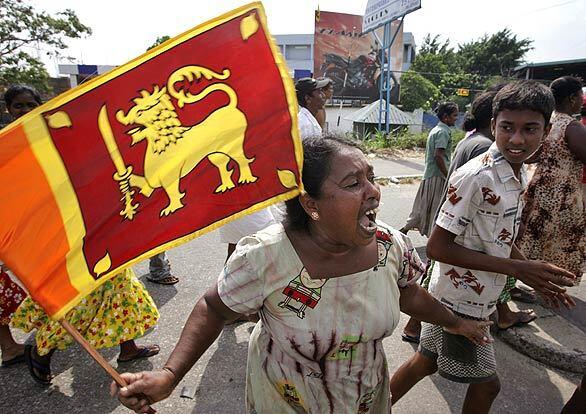 A Sri Lankan woman waves the national flag as she celebrates the military's announced victory over Tamil Tiger rebels.