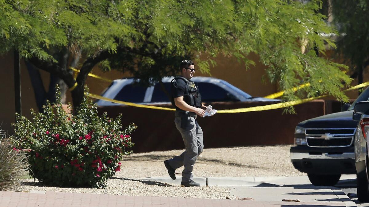 Police surrounded the Scottsdale, Ariz., hotel where the suspect in several killings was staying Monday.