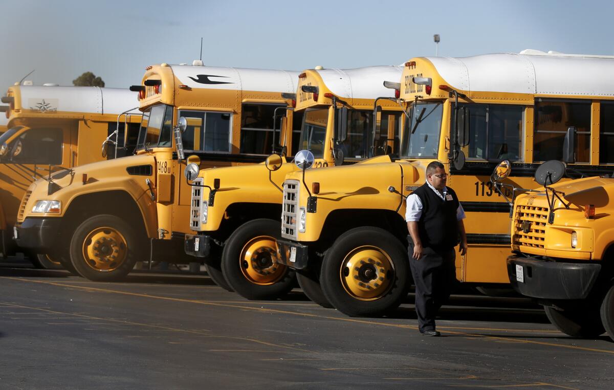 LAUSD school buses sit idle in the Gardena Garage after school officials closed all campuses in the district following an unspecified threat.