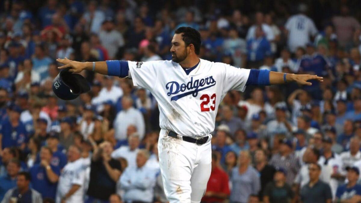 Dodgers first baseman Adrian Gonzalez signals that he's safe after getting tagged out at home plate by Cubs catcher Willson Contreras during Game 4 of the National League Championship Series on Oct. 19.