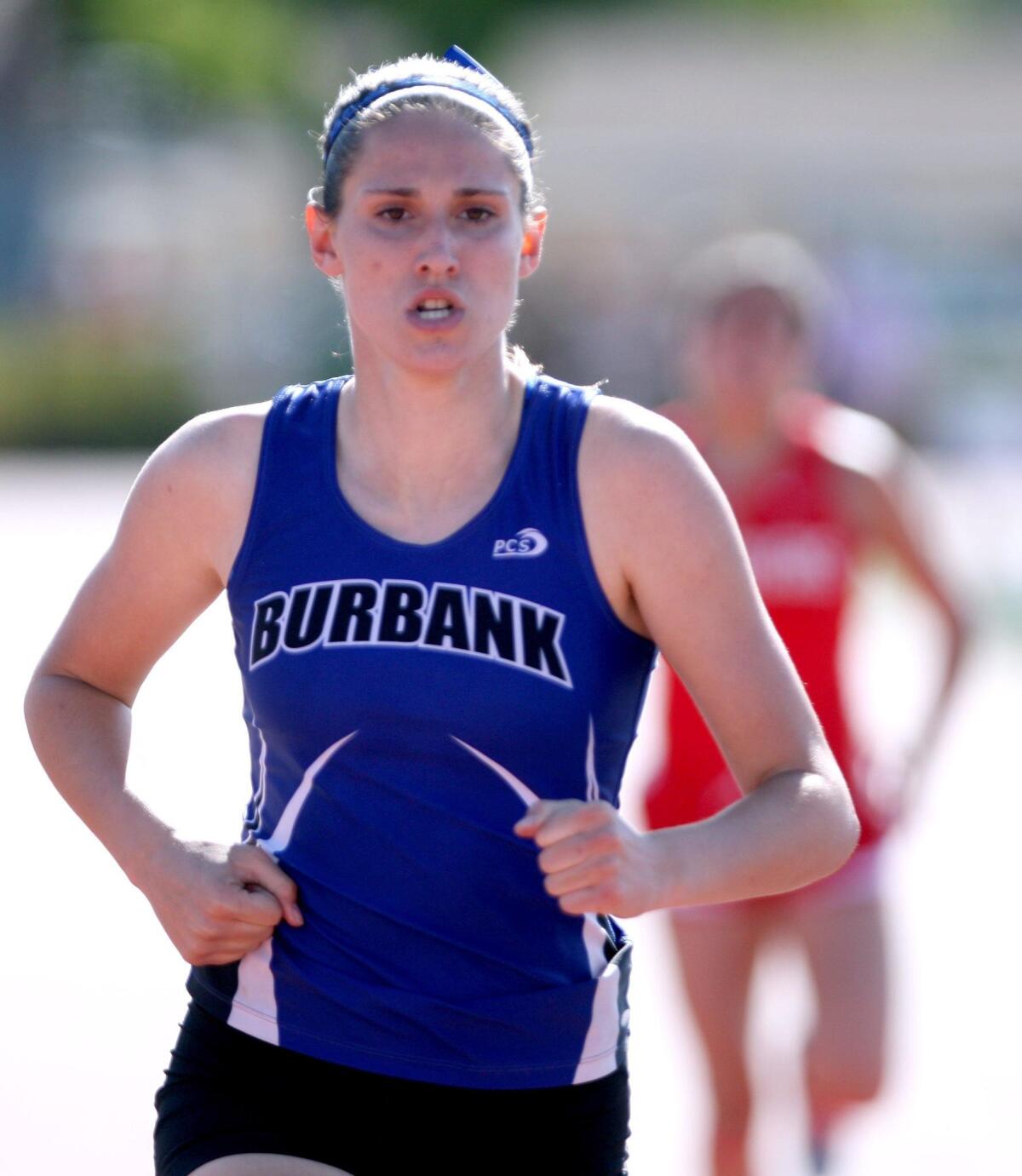 Burbank High School's Kira Bochard wins the 400-meter race vs. Burroughs High School at Burroughs in Pacific League track meet, in Burbank on Wednesday, April 20, 2016.