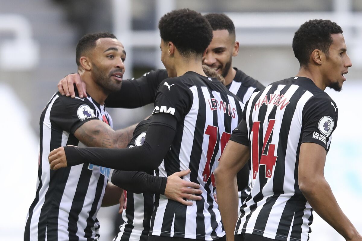 Newcastle's Callum Wilson, left celebrates with team mates after scoring his side's second goal during an English Premier League soccer match between Newcastle United and Everton at the St. James' Park stadium in Newcastle, England, Sunday Nov. 1, 2020.(Alex Pantling/Pool via AP)