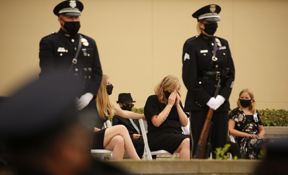 A woman grieves for her partner who died of COVID-19.