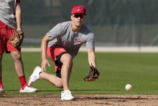 St. Louis Cardinals' Tommy Edman takes grounders during a spring training baseball workout Thursday, Feb. 15, 2024, in Jupiter, Fla. (AP Photo/Jeff Roberson)