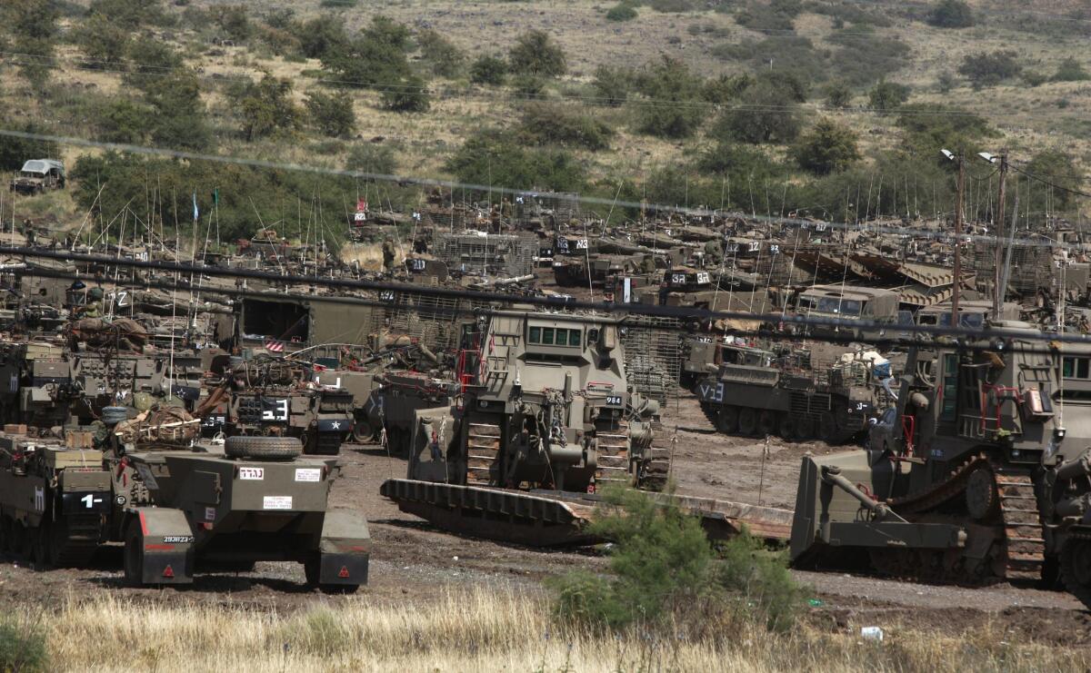 Israeli tanks are seen by the Israeli-Syrian border before the start of a military exercise.