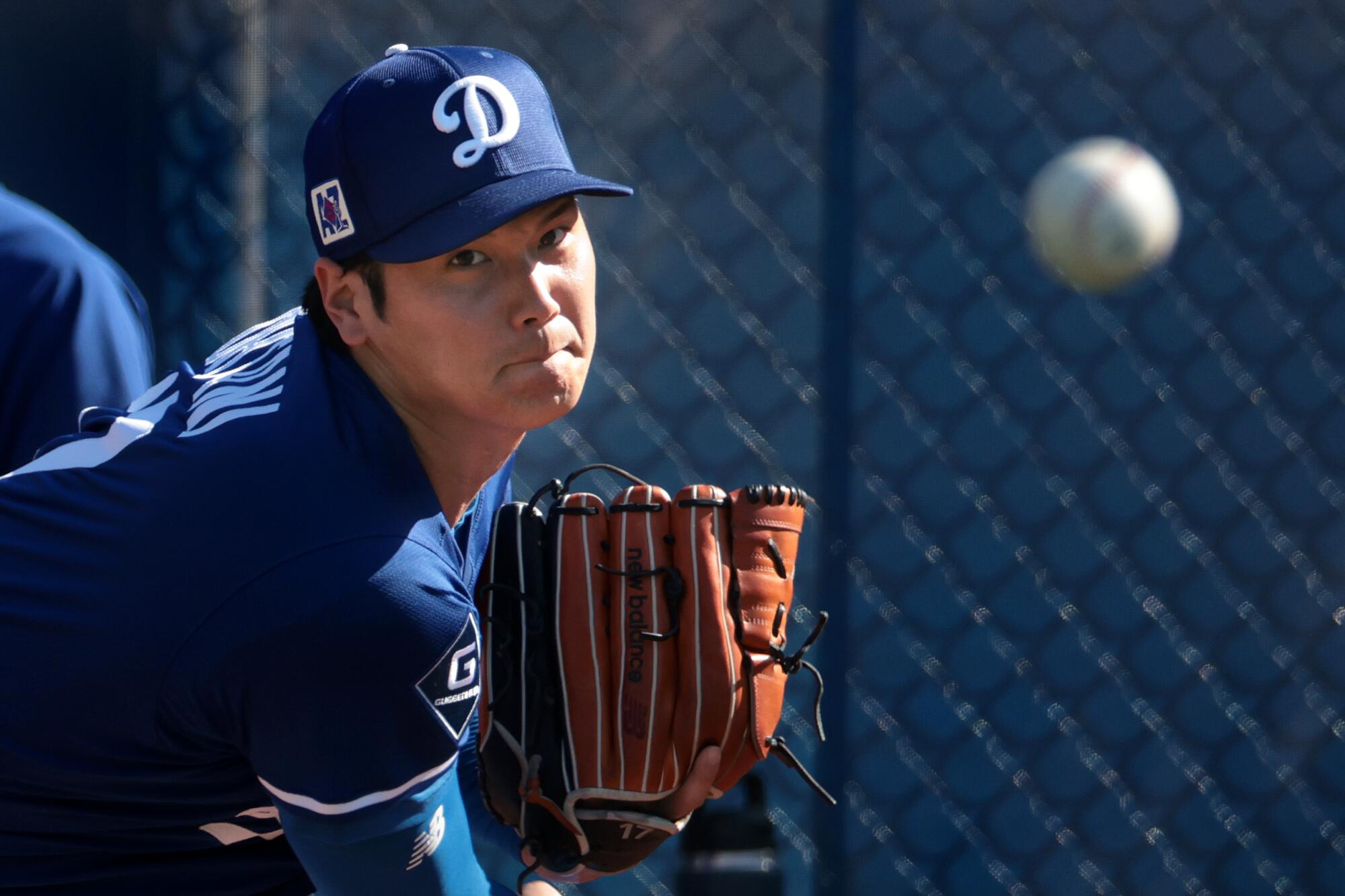 Dodgers pitcher Shohei Ohtani throws a bullpen session at Camelback Ranch last month.