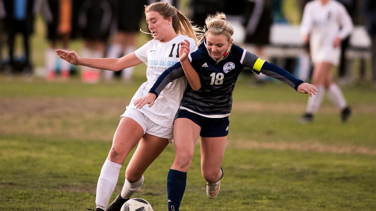 Corona del Mar's Katharine Caston, left, and Newport Harbor's Scout Farmer battle for the ball during the Battle of the Bay on Dec. 21, 2017.