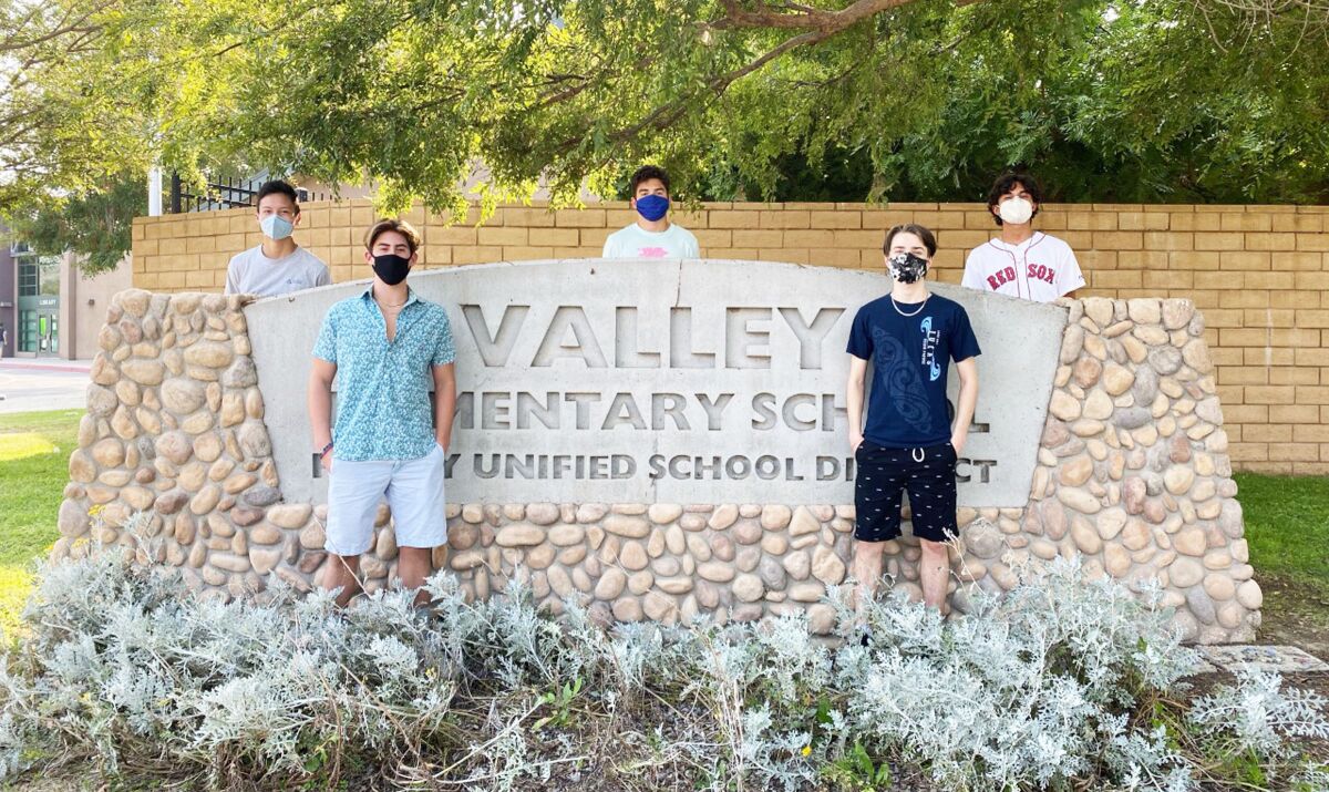 Brandon Shen, Sean Danahy, Max Anger, Drew Floyd and Juan Montano in front of their former elementary school.