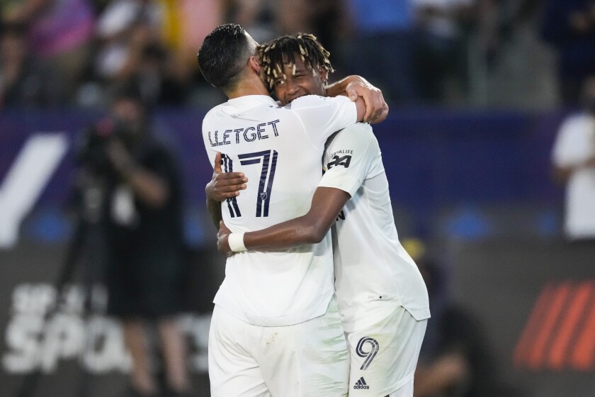 Los Angeles Galaxy midfielder Sebastian Lletget (17) celebrates with midfielder Kevin Cabral (9) after Cabral scored a goal during the first half of an MLS soccer game against FC Dallas Wednesday, July 7, 2021, in Carson, Calif. (AP Photo/Ashley Landis)