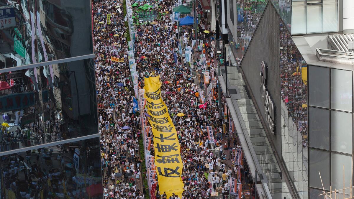 Thousands of protesters march through the streets of Hong Kong during a pro-democracy rally on July 1.