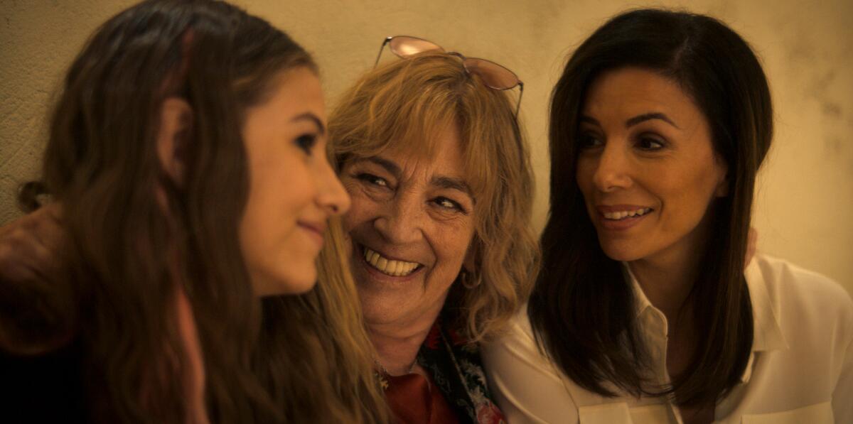 Three women seen from the shoulder up.