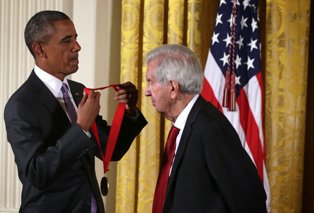 Larry McMurtry stands with President Obama as the president presents him a National Humanities Medal in 2015.