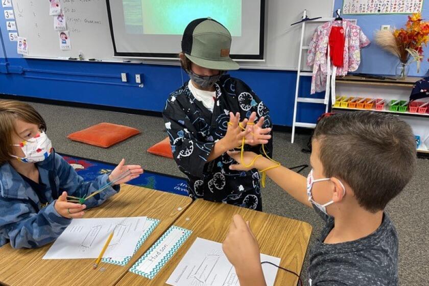 Third graders, from left, Hudson Bass, Alexander Fermin and John Gormican, practice their new toy making skills. 