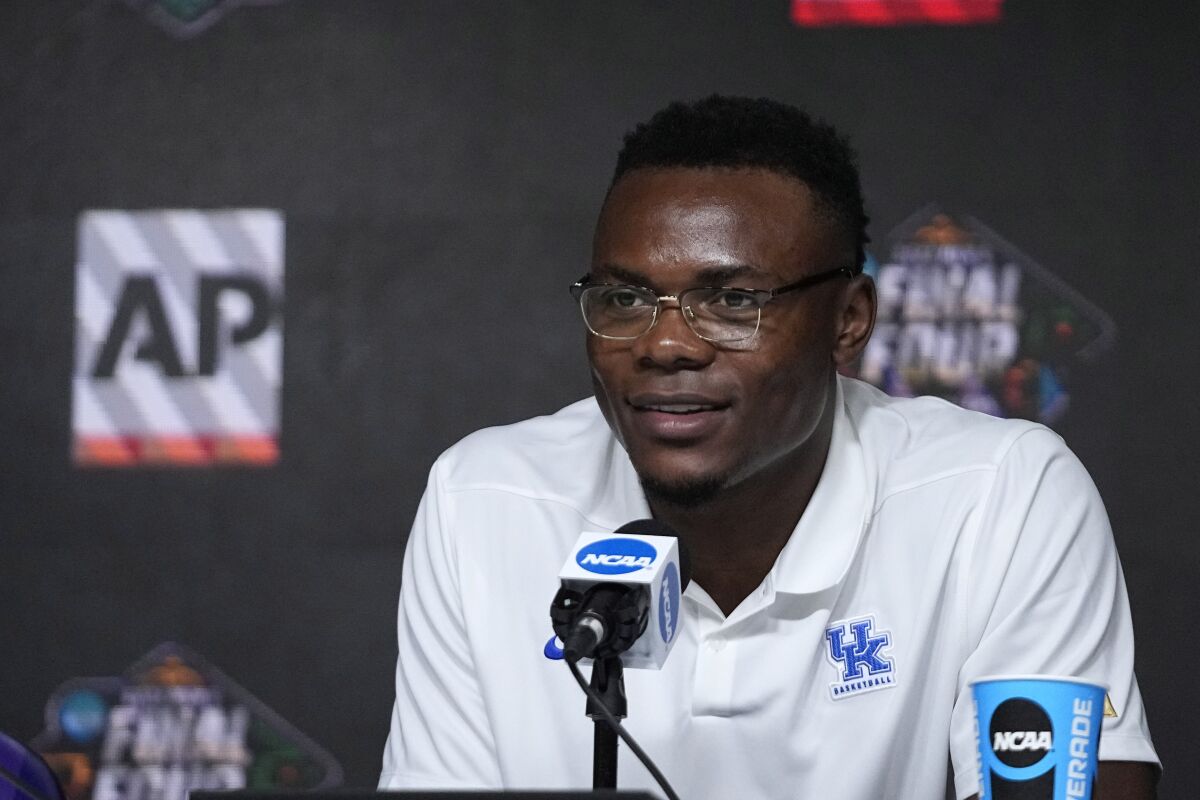 Oscar Tshiebwe of Kentucky speaks as he is introduced as The Associated Press men's basketball player of the year, in New Orleans, Friday, April 1, 2022. The 6-foot-9, 255-pound junior received 46 of 60 votes from a national media panel. Wisconsin's Johnny Davis was second with 10 votes. (AP Photo/Gerald Herbert)