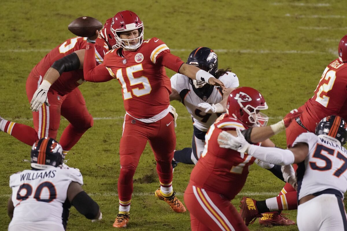 Kansas City Chiefs quarterback Patrick Mahomes (15) throws under pressure against the Denver Broncos in the second half of an NFL football game in Kansas City, Mo., Sunday, Dec. 6, 2020. (AP Photo/Charlie Riedel)
