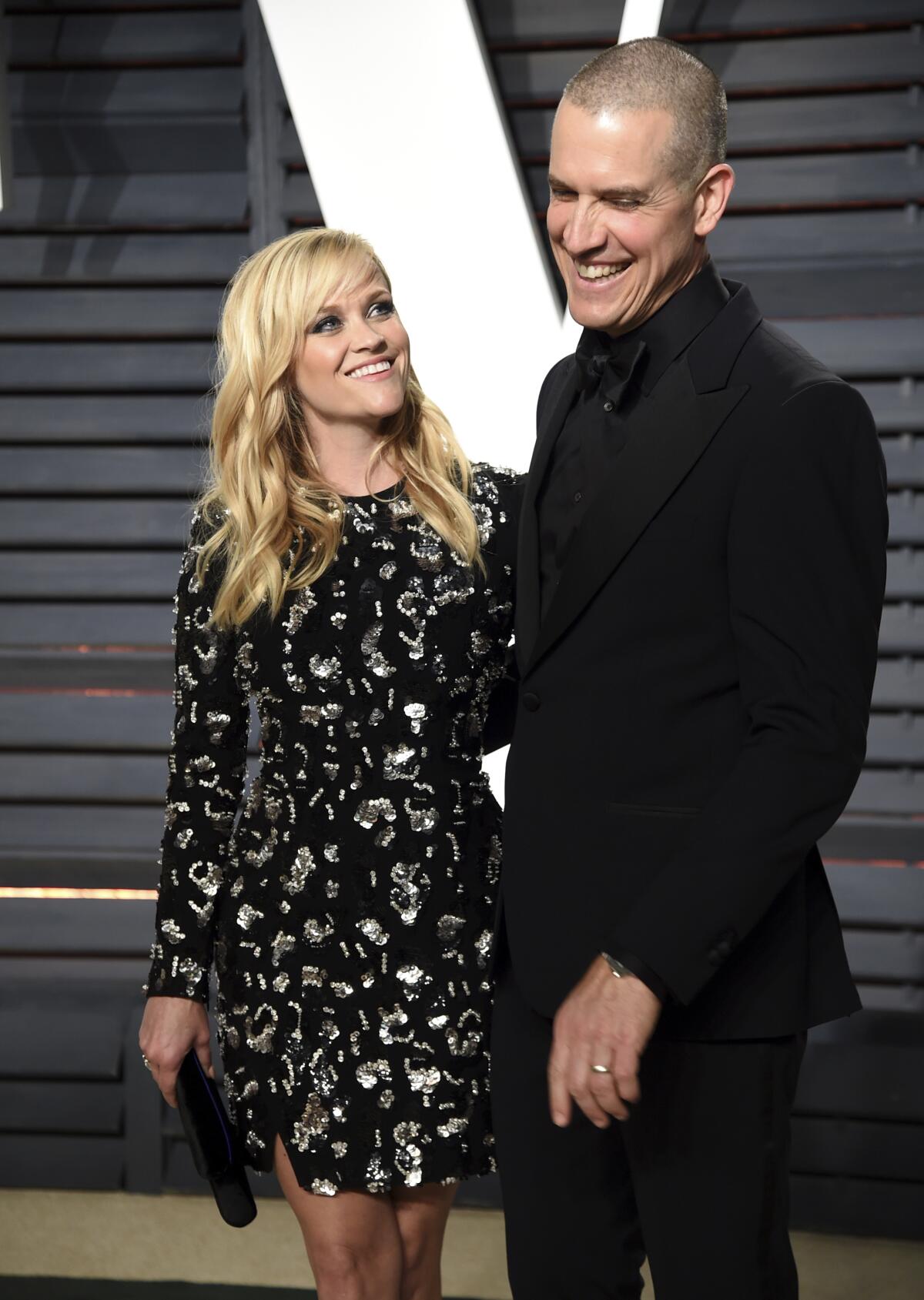Reese Witherspoon and husband Jim Toth pose upon arrival at an event