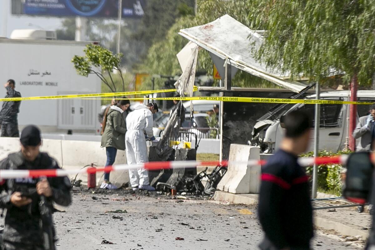 Forensic officers work on a blast site near the U.S. Embassy in Tunis on Friday.