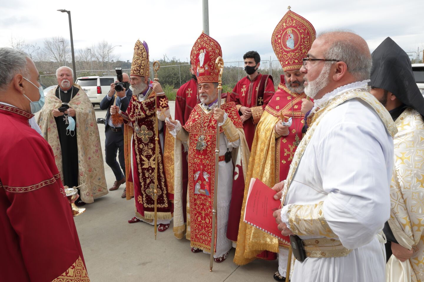 Father Moushegh Tashjian (Founding Pastor St. Mary Armenian Church, Costa Mesa), Archbishop Barkev Martirosyan (Former Primate of Artsakh, Armenia), Archbishop Hovnan Derderian (Primate, Western Diocese of Armenian Church), Bishop Bagrat Galastanyan (Primate of the Diocese of Tavush, Armenia), and Father Pakrad Berejekian (Parish Priest, far right in white robe) prepare to preside over the consecration and church naming ceremony at the new Armenian Church in San Diego.