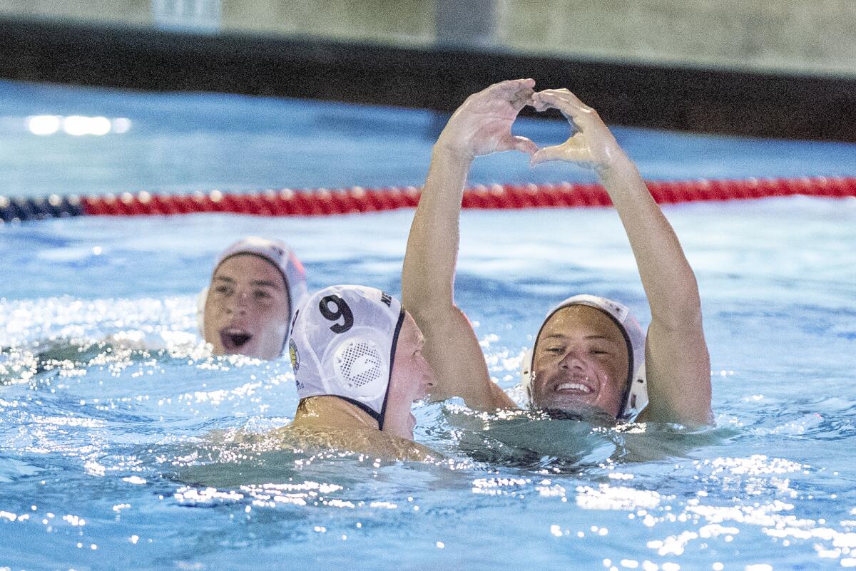 Newport Harbor's Finn Genc (9) and Billy Rankin, right, celebrate after beating Mater Dei on Wednesday night.