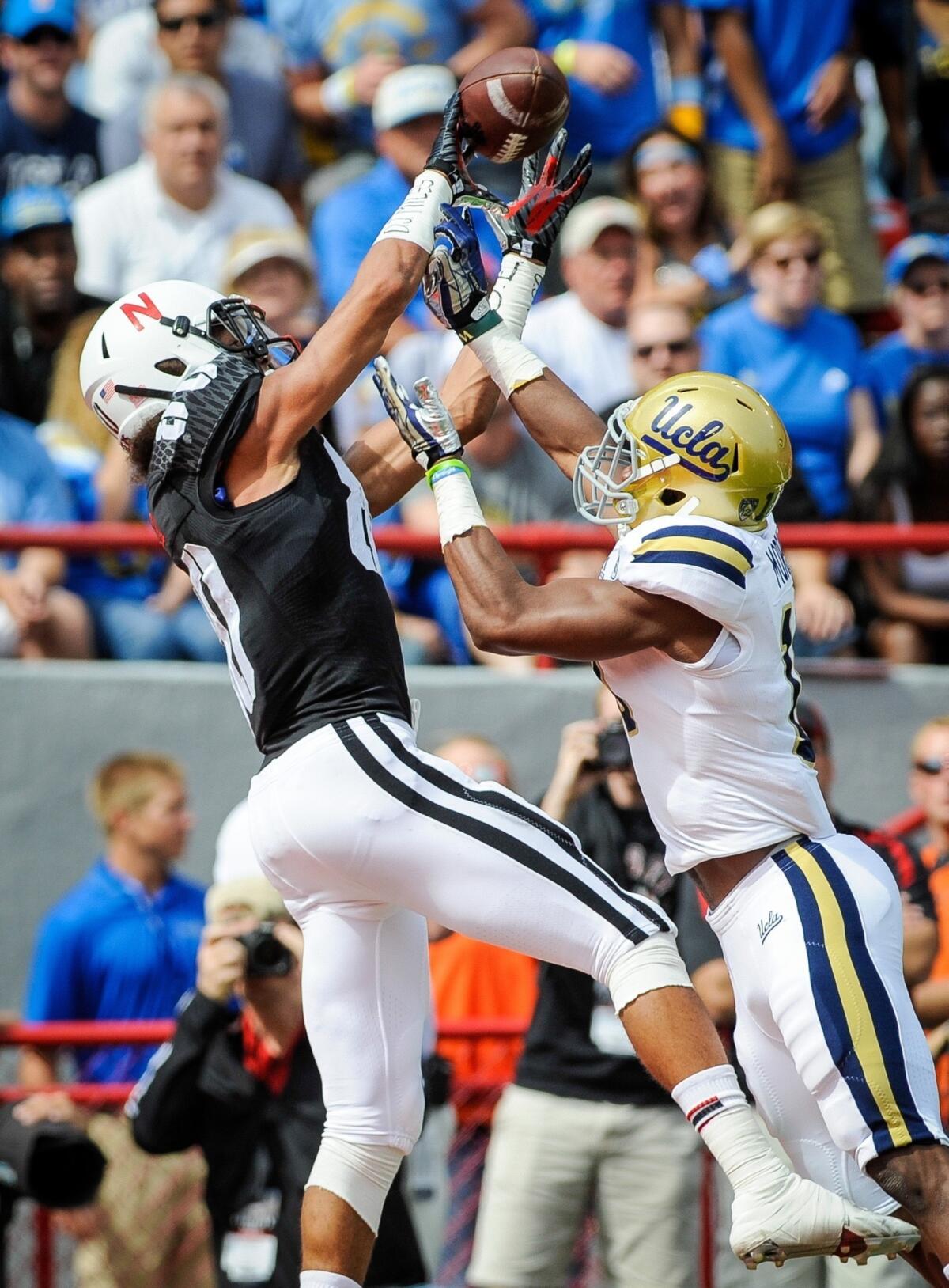 UCLA cornerback Fabian Moreau, right, can't stop Nebraska wide receiver Kenny Bell from catching a touchdown pass during the first half of the Bruins' 41-21 comeback victory Saturday.