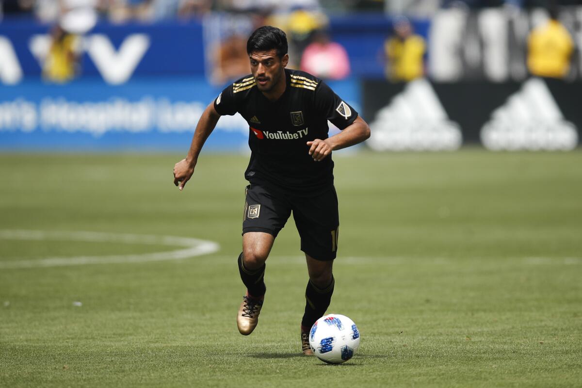 Los Angeles FC's Carlos Vela dribbles the ball during the first half of an MLS soccer match against the Los Angeles Galaxy Saturday, March 31, 2018, in Carson, Calif. (AP Photo/Jae C. Hong)