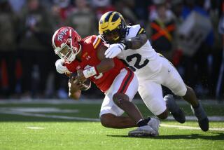 Maryland quarterback Taulia Tagovailoa gets sacked by Michigan defensive end Jaylen Harrell on Nov. 18 in College Park.