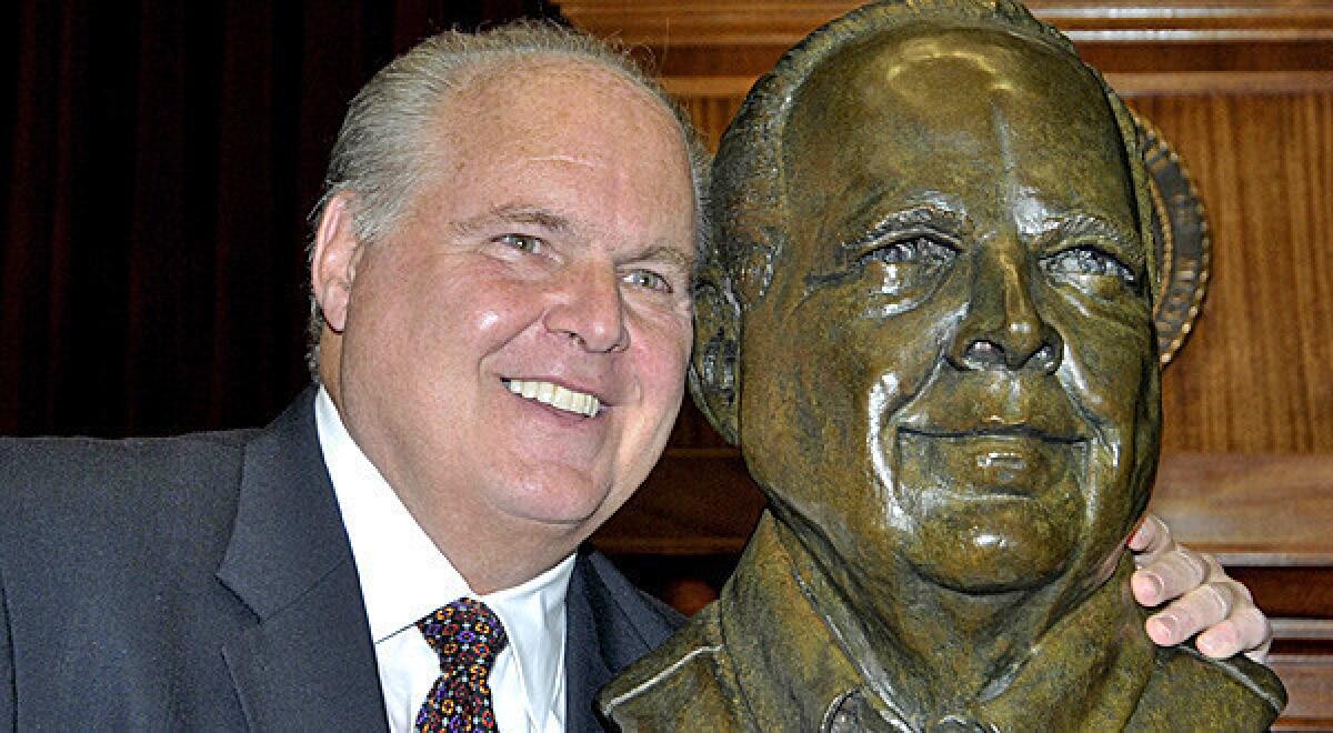 Rush Limbaugh with a bust in his likeness during a ceremony inducting him into the Hall of Famous Missourians.