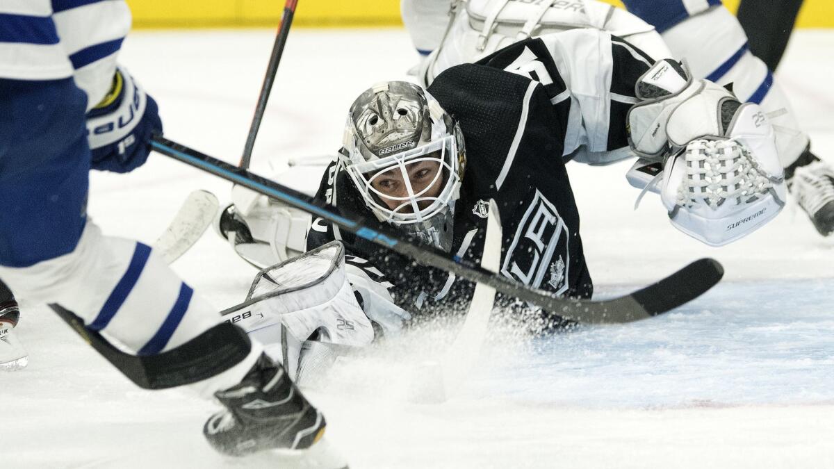 Kings goaltender Peter Budaj reaches to stop a shot during the first period against the Toronto Maple Leafs at Staples Center on Nov. 13.