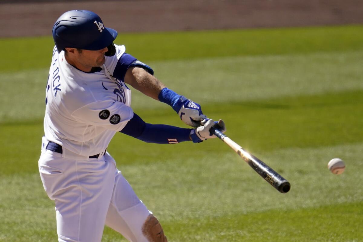 Dodgers outfielder AJ Pollock drives in a run against the Cincinnati Reds on April 28.