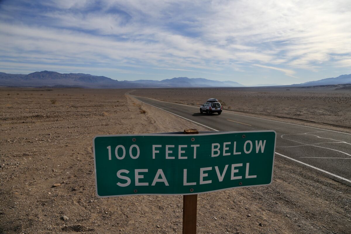 A sign in Death Valley National Park marks where the terrain drops to '100 feet below sea level.'