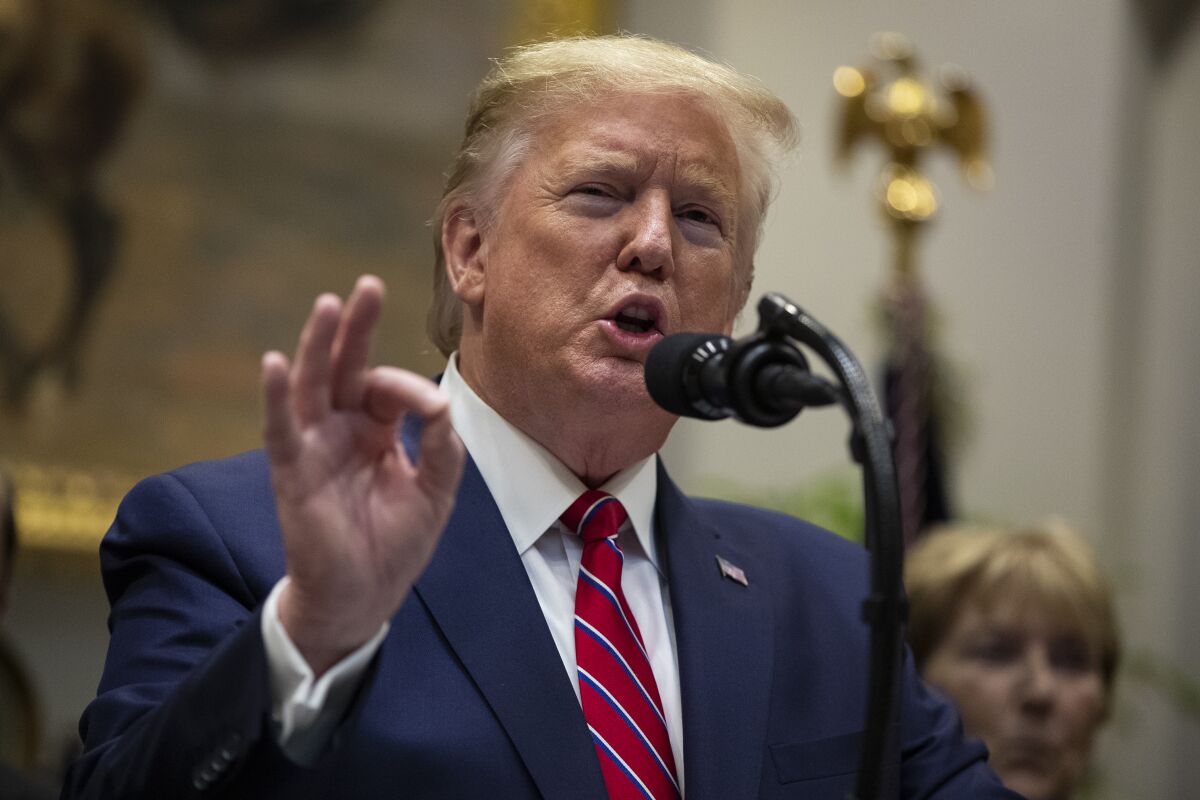 Donald Trump gestures with his hand while speaking