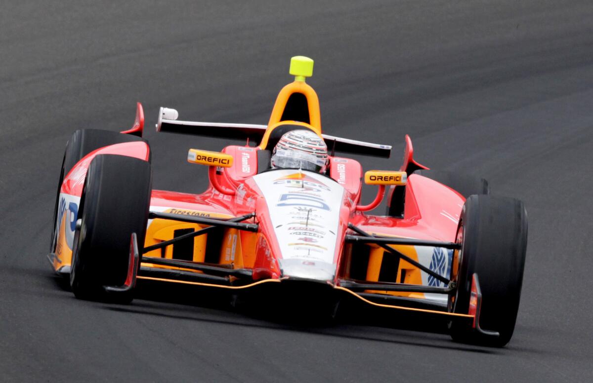 E.J. Viso drives through the first turn during practice for the Indianapolis 500 race.