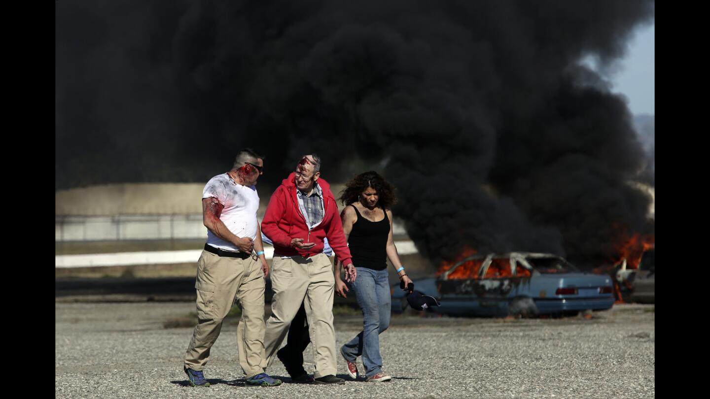 Volunteers pretending to be injured passengers take part in a disaster drill at Bob Hope Airport in Burbank on March 24.