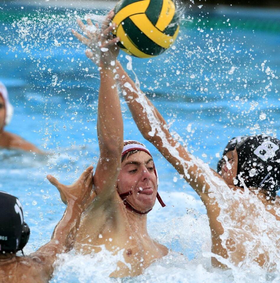 Estancia High's Jason Chesemore, center, scores on Costa Mesa's Sagang Wee, left, and Nick Warner, right, during the second half in an Orange Coast League game on Wednesday.