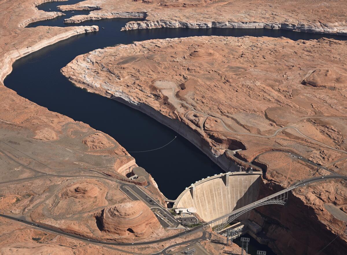 Aerial view of Glen Canyon Dam holding back Colorado River water to create Lake Powell