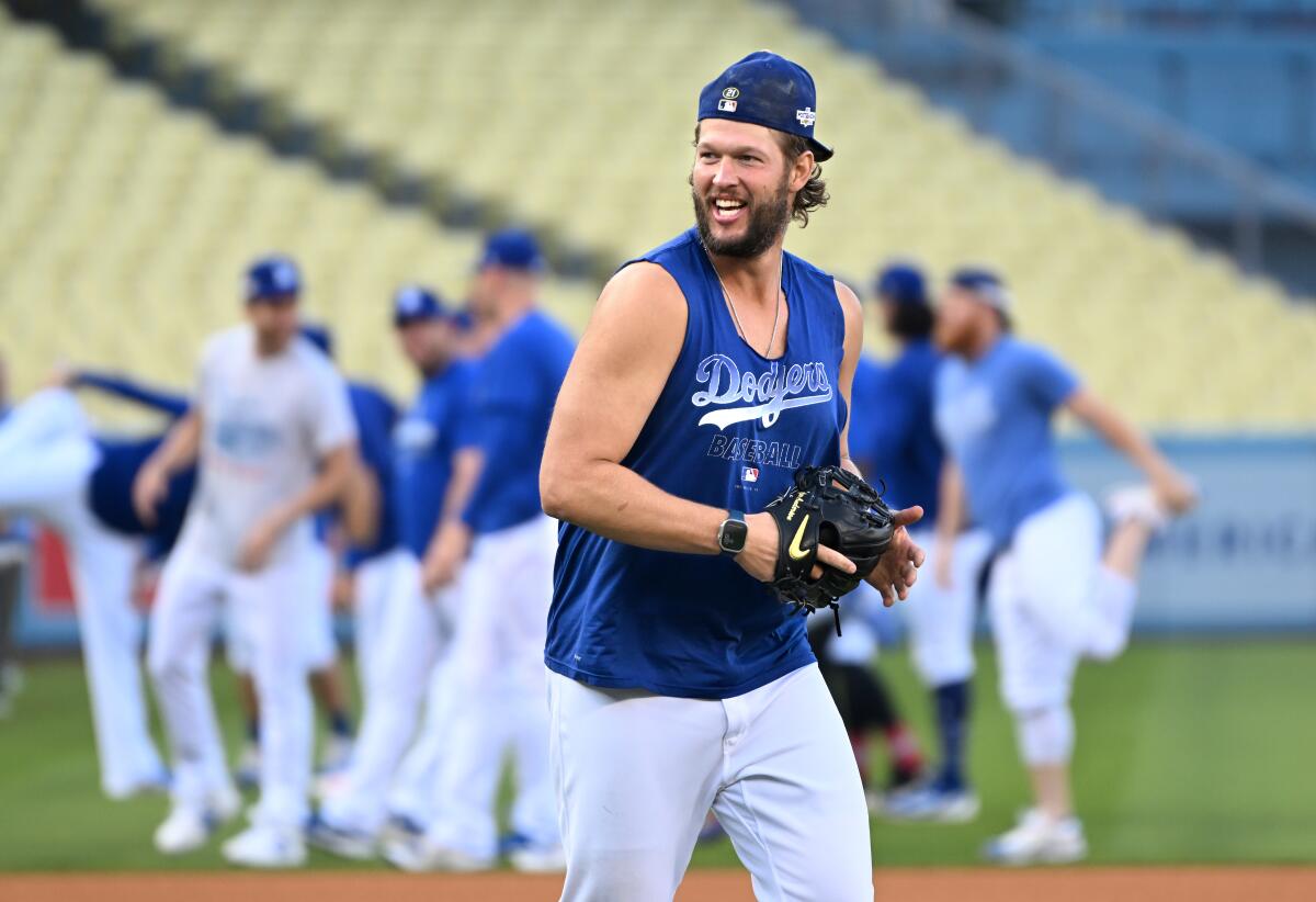 Dodgers pitcher Clayton Kershaw has a little fun during a team practice Monday at Dodger Stadium.