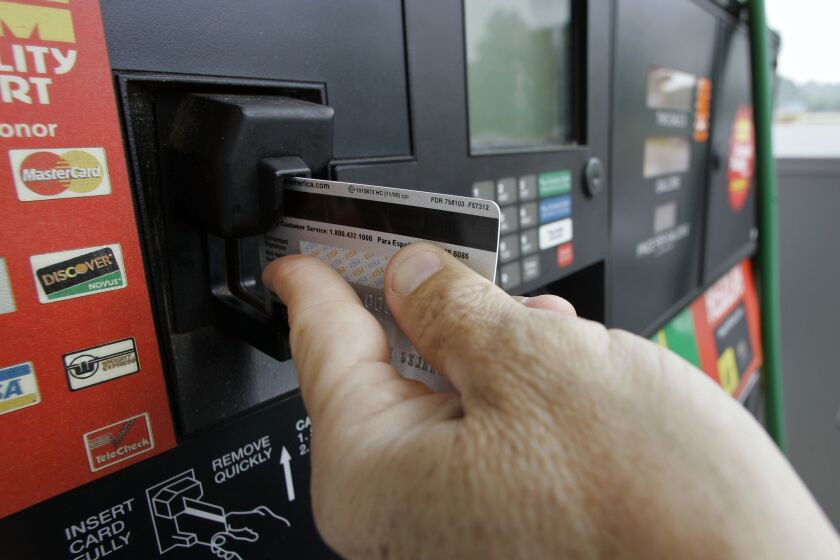 A customer swipes his credit card at a gas station pump in Morganton, N.C., Friday, June 15, 2007. As the price of gasoline continues to rise, rules to prevent credit card fraud at the nation's pumps are confusing consumers who just want a full tank of gas. Caps on transaction amounts or the total dollar amount of gas a customer can pump into their car are limiting some drivers of gas-guzzling vehicles. (AP Photo/Chuck Burton) ORG XMIT: NCCB107