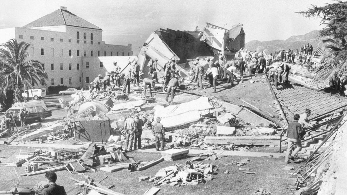 Workers swarm the VA hospital in Sylmar that was destroyed in the 1971 earthquake centered nearby. 
