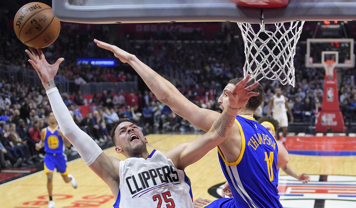 Clippers guard Austin Rivers, left, shoots over Golden State Warriors guard Klay Thompson during the second half Thursday.